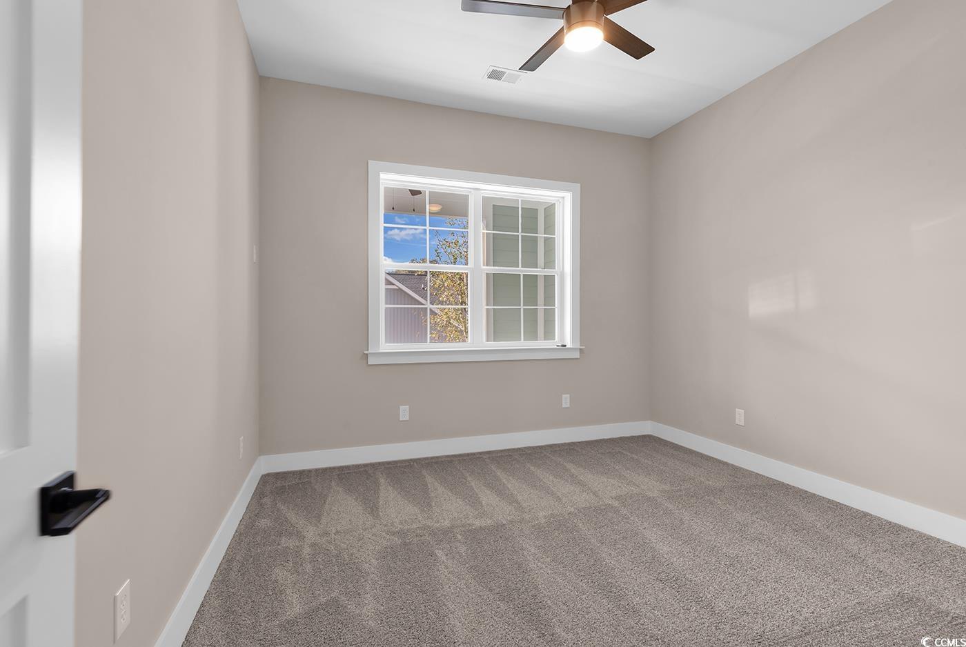 535 Mary Lou Avenue Murrells Inlet, SC 29576 - Photo 22 of 30 Spare room featuring carpet and ceiling fan