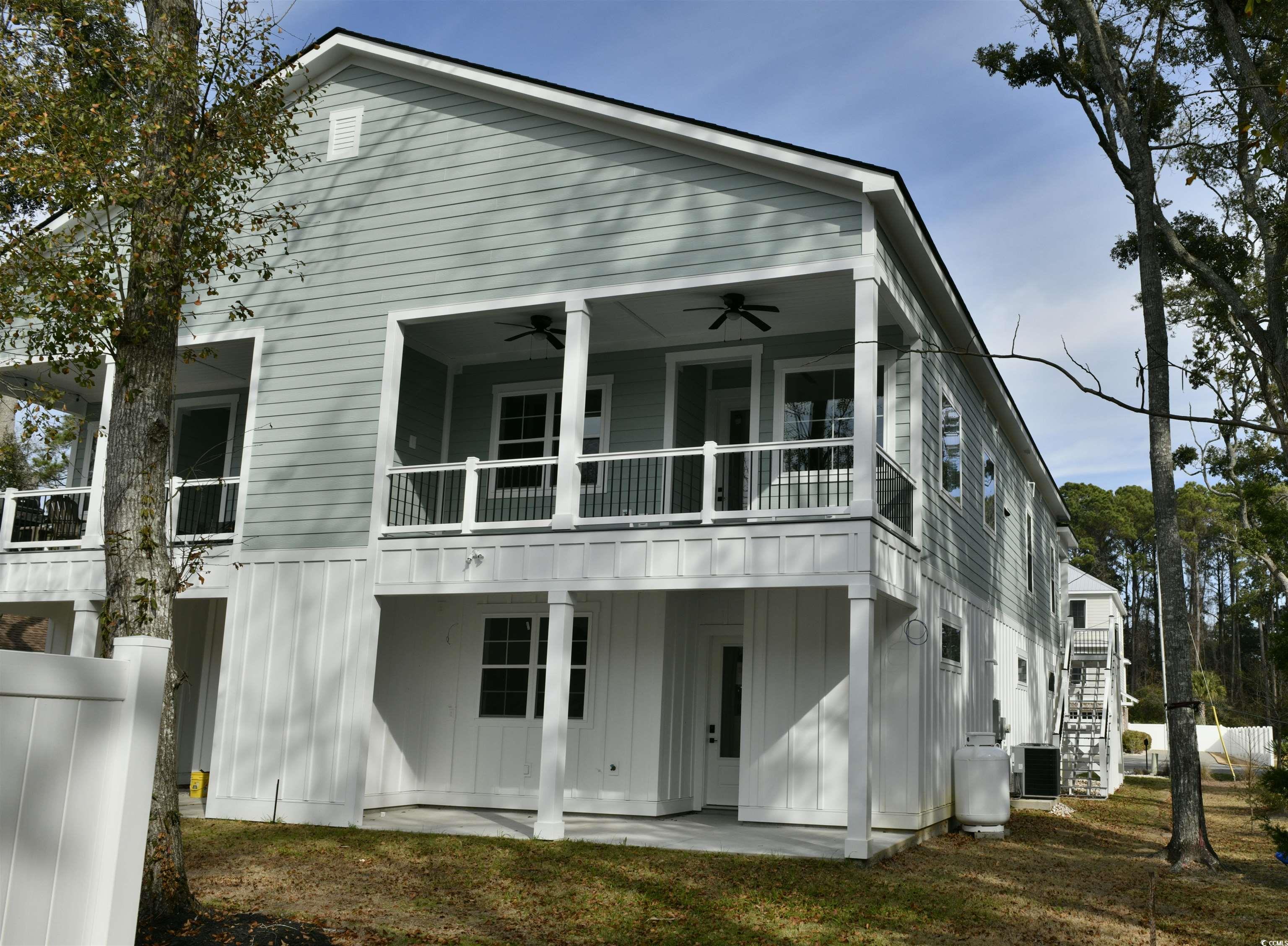 535 Mary Lou Avenue Murrells Inlet, SC 29576 - Photo 4 of 30 Back of property with board and batten siding, ceiling fan, and patio