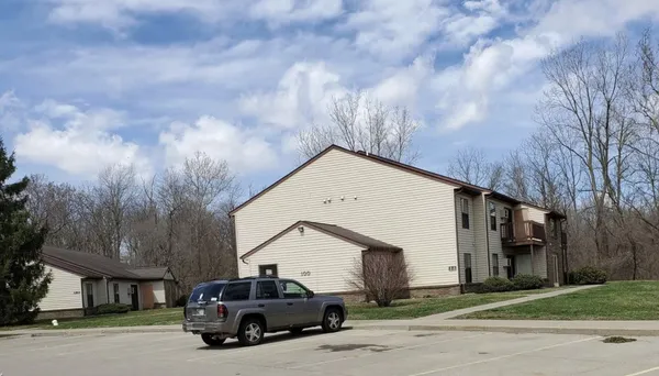 a car parked in front of white house