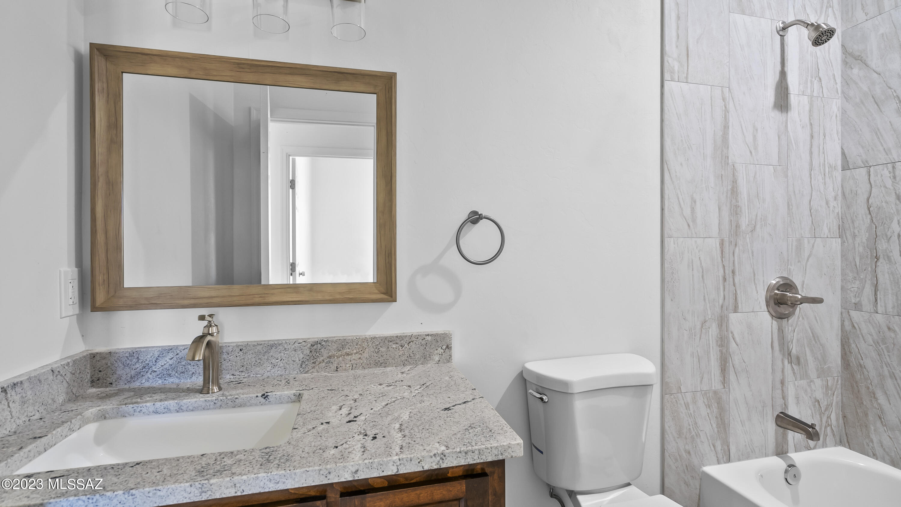 1832 America Court Rio Rico, AZ 85648 - Photo 17 of 19 a bathroom with a granite countertop sink a toilet and a mirror