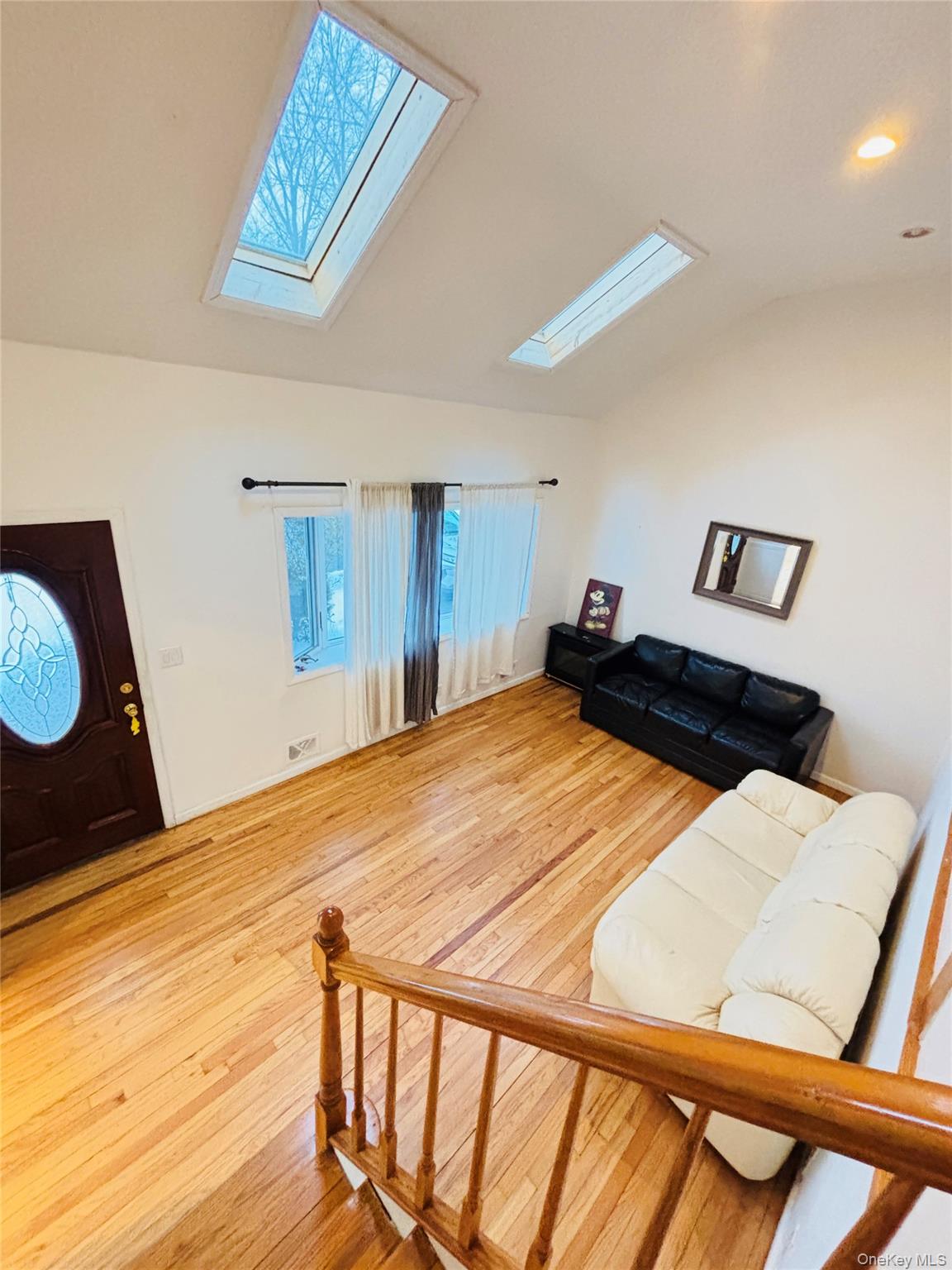 929 Fox Meadow Road Yorktown Heights, NY 10598 - Photo 5 of 39 Living room featuring vaulted ceiling, a bow window two skylights, light wood finished floors, and recessed lighting