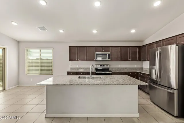 a bathroom with a granite countertop sink a large mirror and a shower
