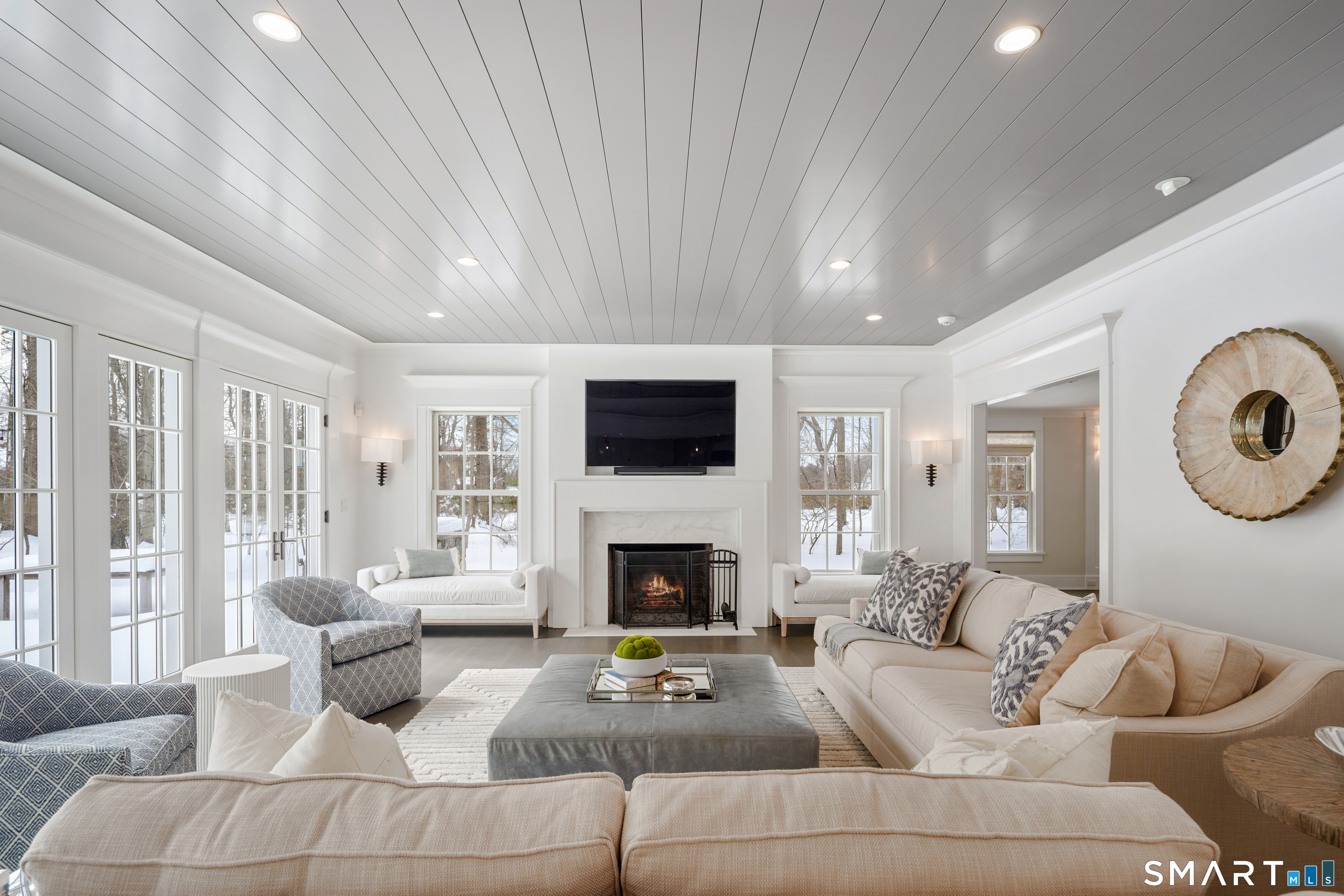 15 Marianne Road Darien, CT 06820 - Photo 9 of 36 a living room with furniture a flat screen tv and a fireplace