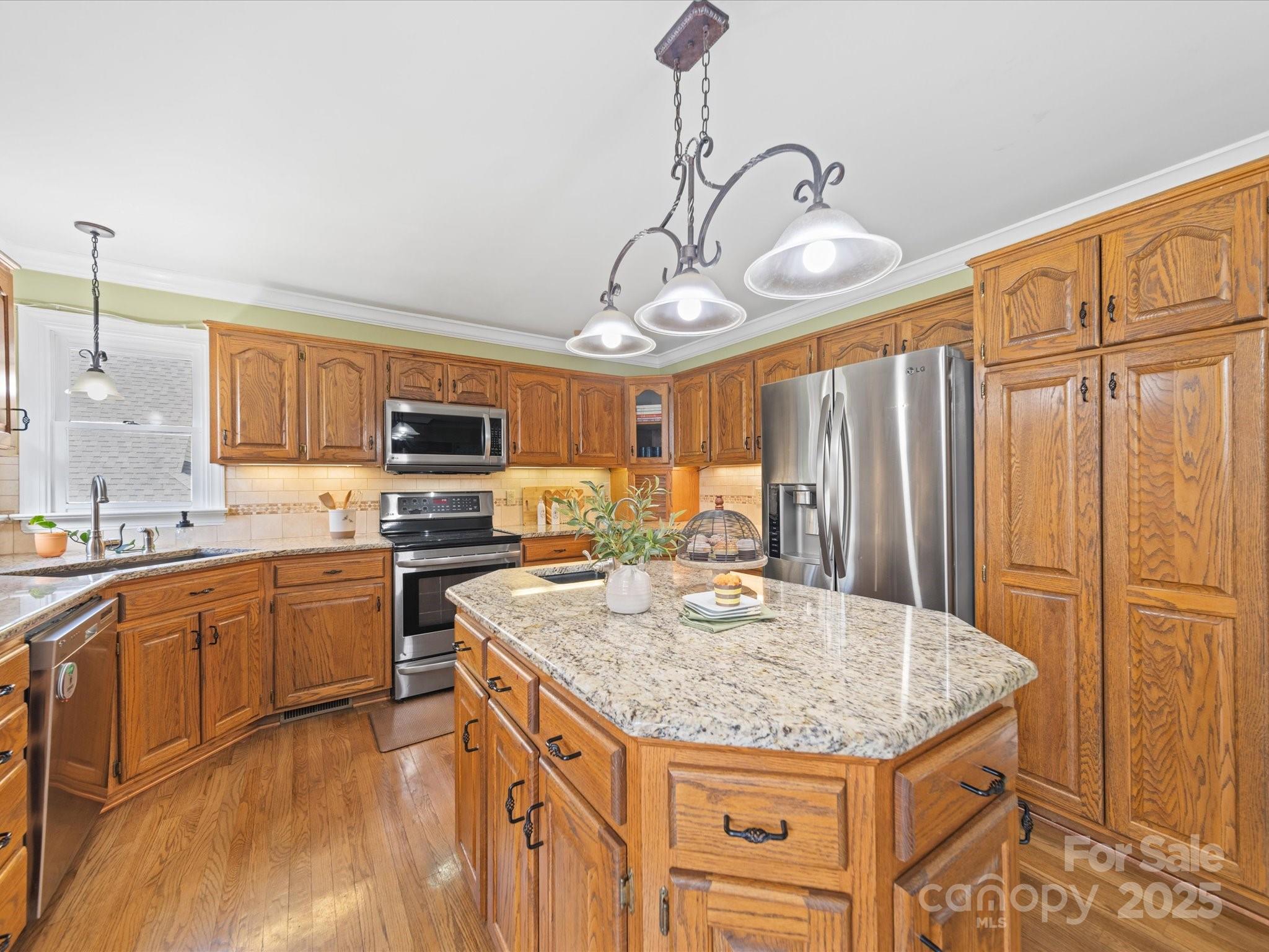 106 Berea Baptist Church Road Stanfield, NC 28163 - Photo 14 of 48 a kitchen with stainless steel appliances granite countertop a sink stove and refrigerator