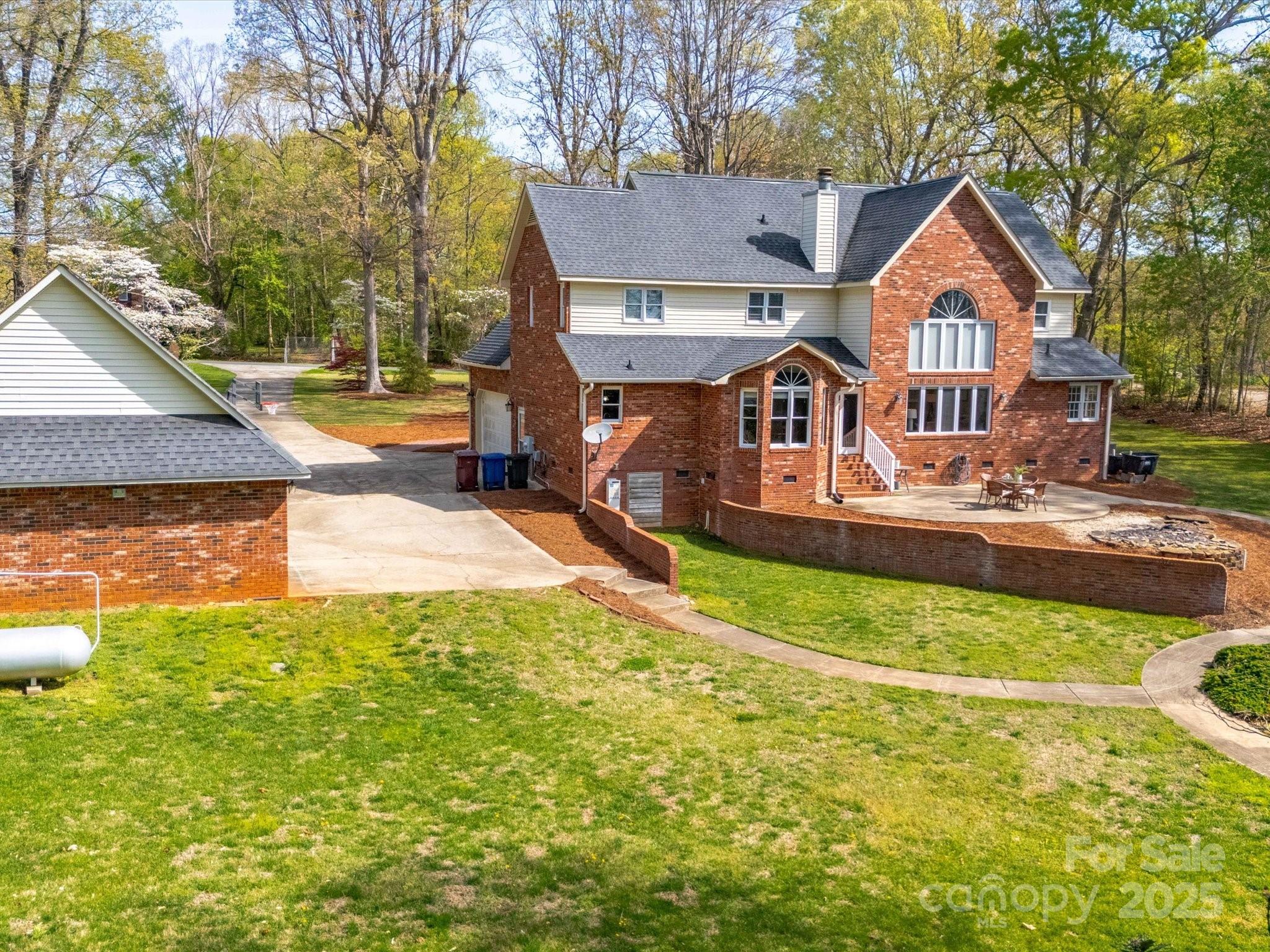 106 Berea Baptist Church Road Stanfield, NC 28163 - Photo 2 of 48 a front view of a house with a yard and trees