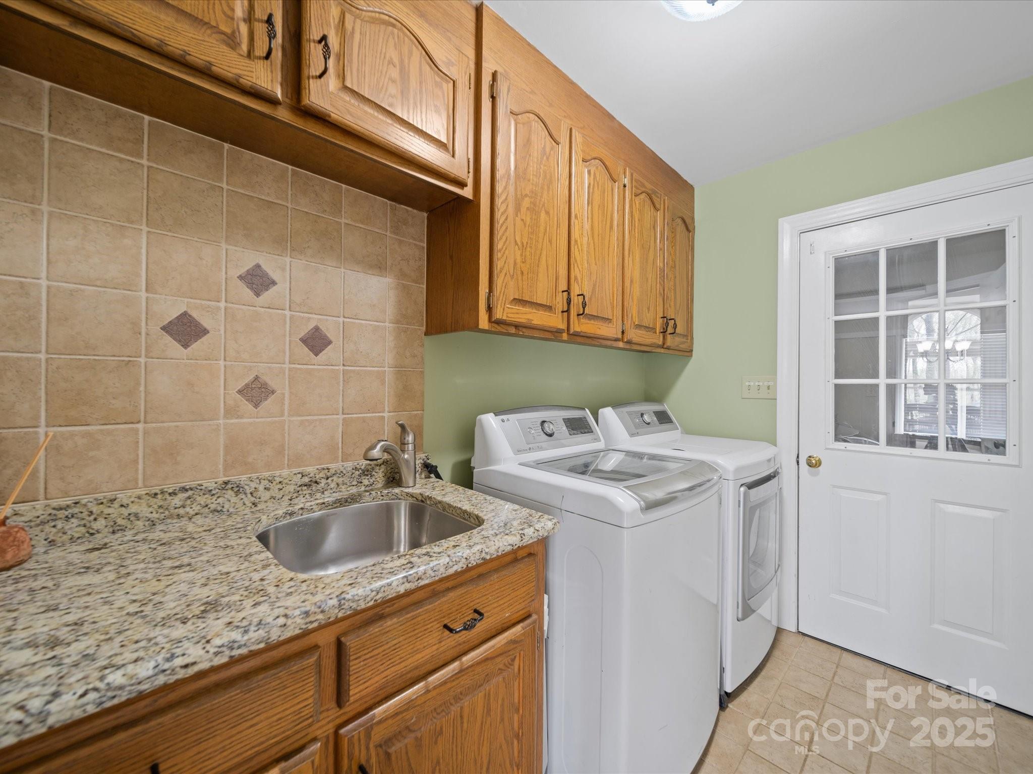106 Berea Baptist Church Road Stanfield, NC 28163 - Photo 22 of 48 a utility room with a sink washer and dryer