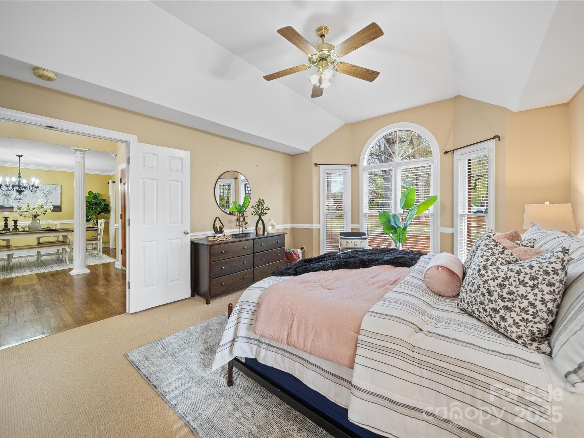 106 Berea Baptist Church Road Stanfield, NC 28163 - Photo 27 of 48 a bedroom with a bed a chandelier and a large window