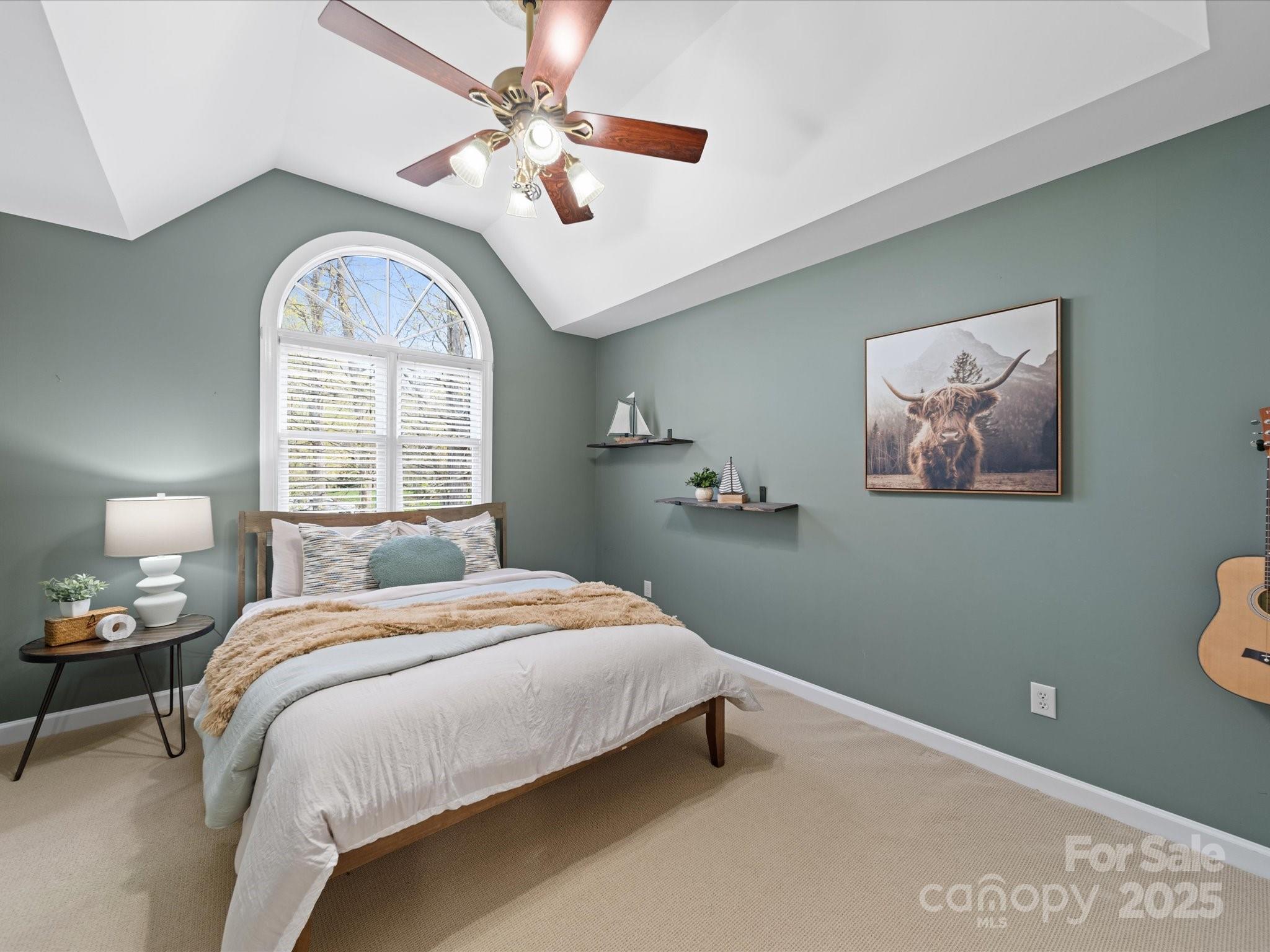 106 Berea Baptist Church Road Stanfield, NC 28163 - Photo 39 of 48 a bedroom with a bed and a chandelier