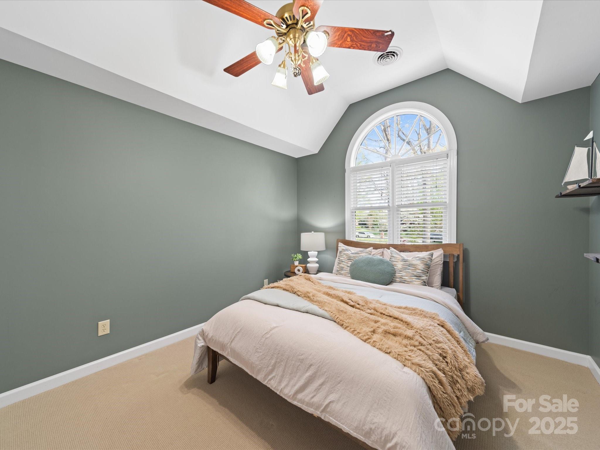 106 Berea Baptist Church Road Stanfield, NC 28163 - Photo 40 of 48 a bedroom with a large bed and a chandelier