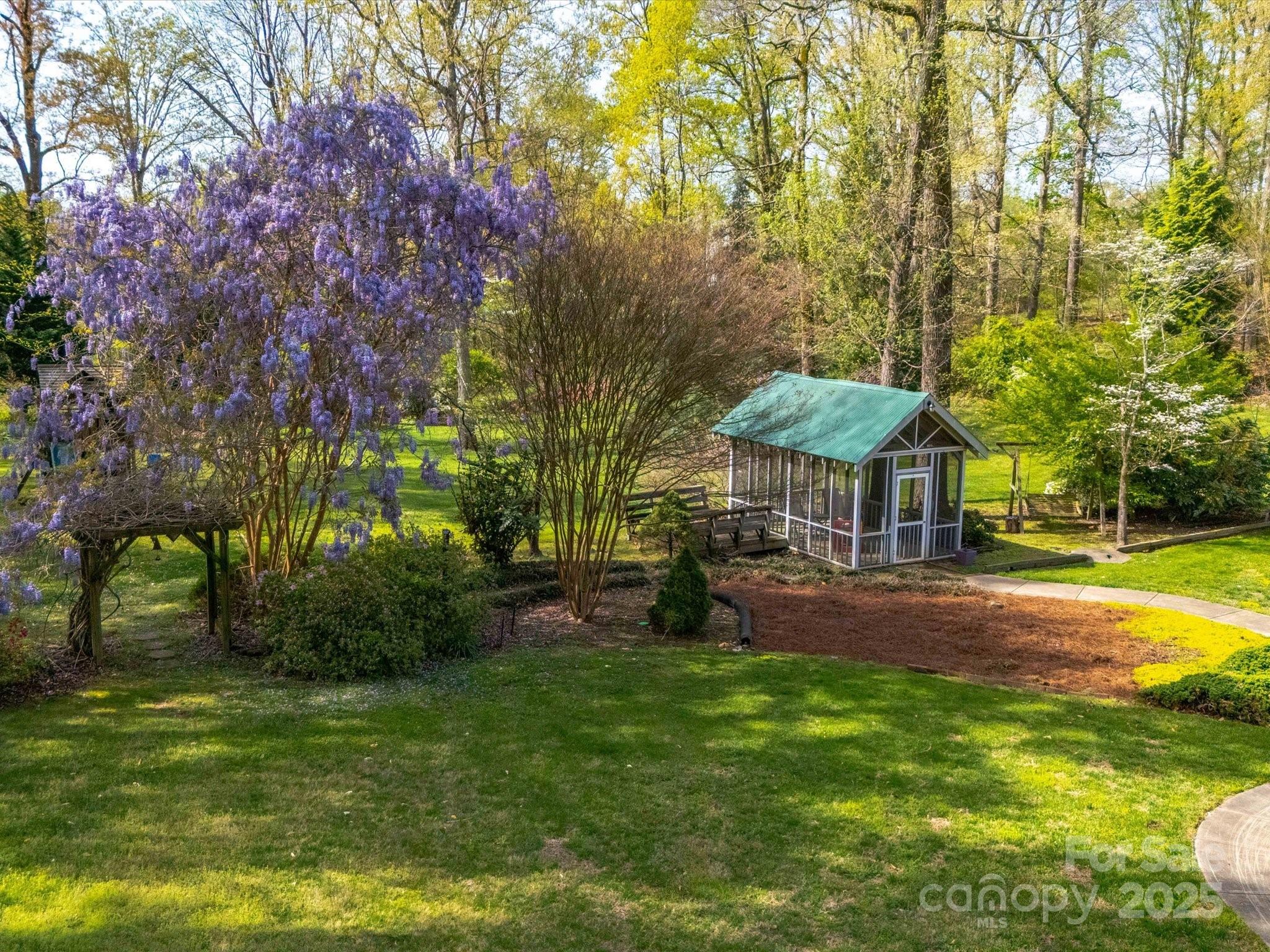 106 Berea Baptist Church Road Stanfield, NC 28163 - Photo 47 of 48 a view of a swimming pool with lawn chairs under an umbrella