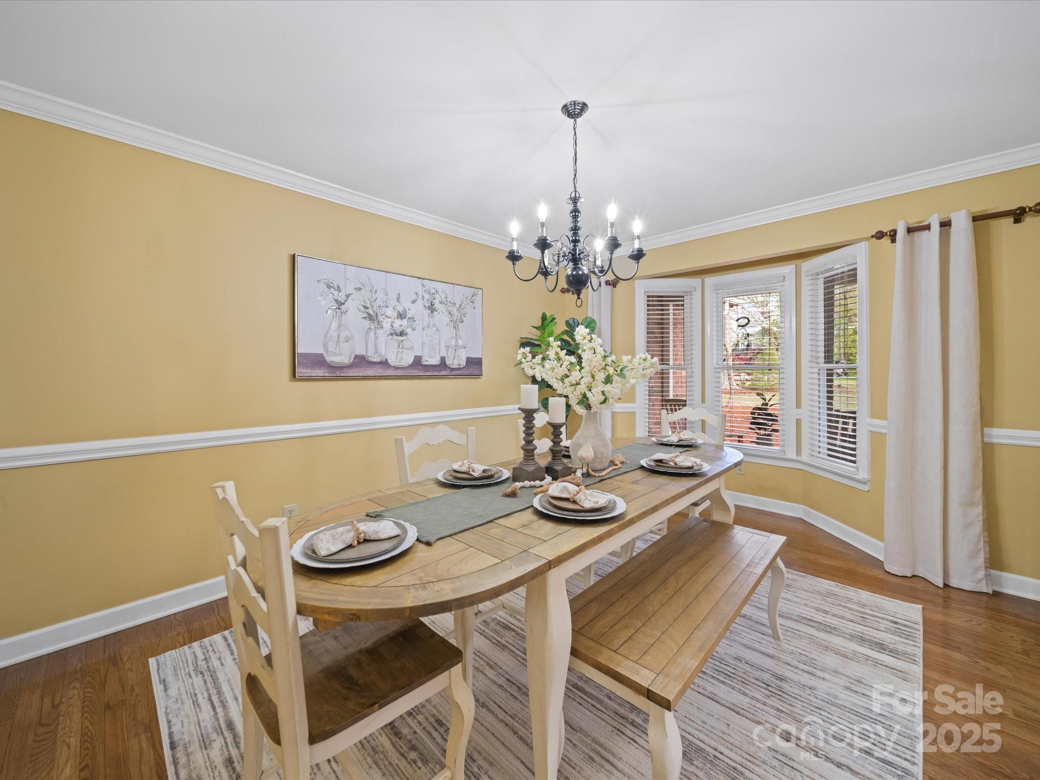 106 Berea Baptist Church Road Stanfield, NC 28163 - Photo 9 of 48 a view of a dining room with furniture wooden floor and chandelier