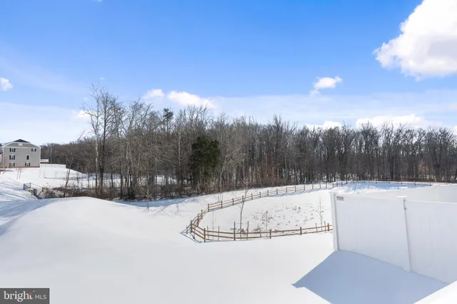 a kitchen with stainless steel appliances a sink a stove a refrigerator and cabinets