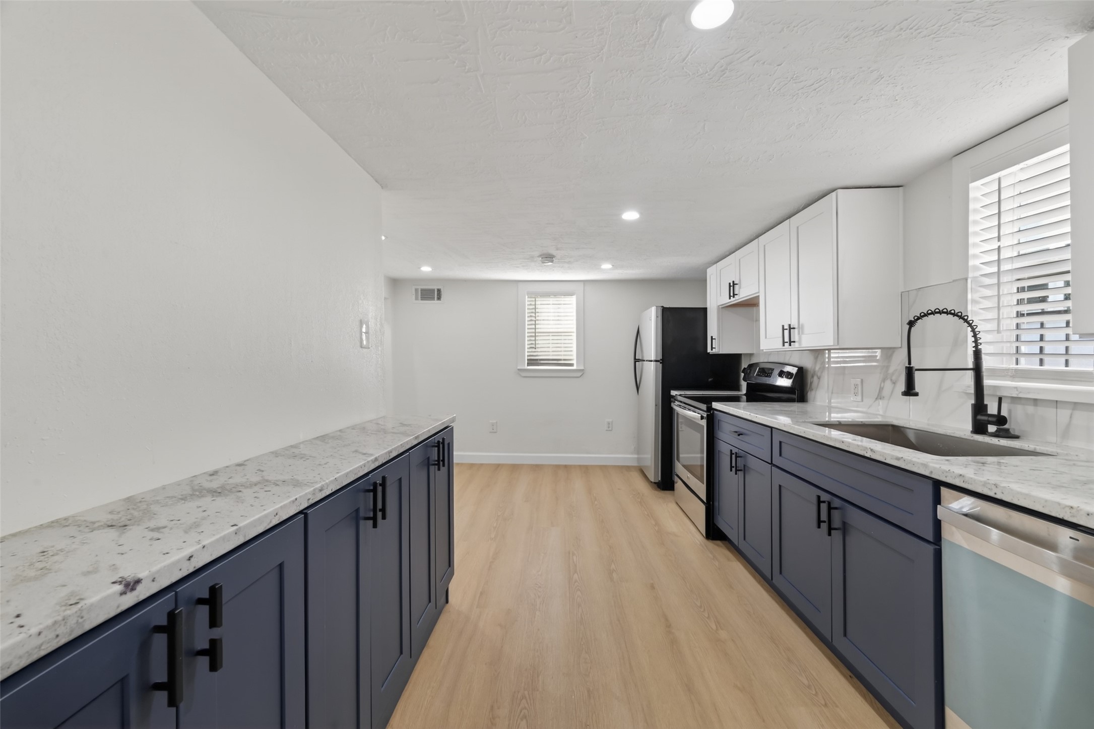 2118 Webster Street, Unit 3 Houston, TX 77003 - Photo 12 of 29 a kitchen with granite countertop a sink and cabinets