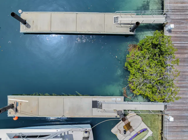 an aerial view of a house with garden space and sitting area
