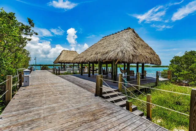a view of a patio with a table and chairs under an umbrella