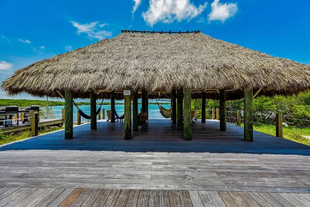 a view of a patio with a table and chairs under an umbrella