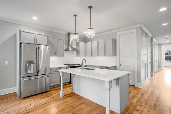 a kitchen with stainless steel appliances a sink stove and refrigerator
