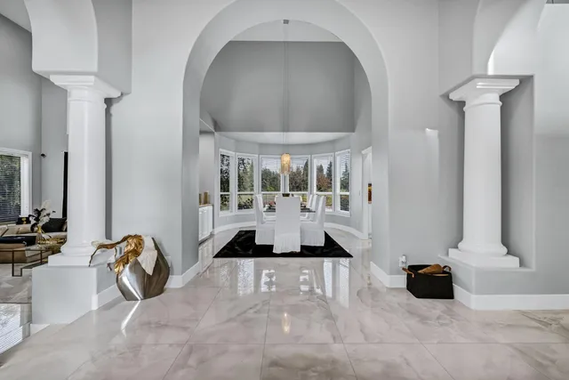 a kitchen with granite countertop white cabinets and stainless steel appliances