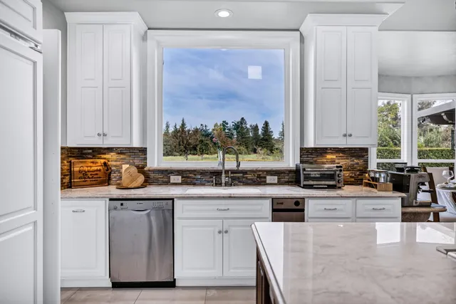 a view of a house with swimming pool and a yard