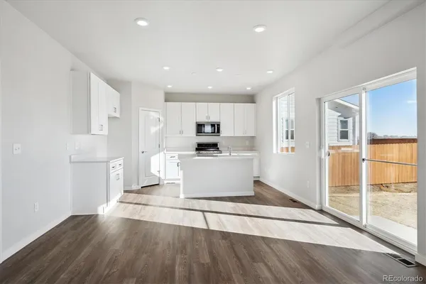 a view of kitchen with cabinets and wooden floor