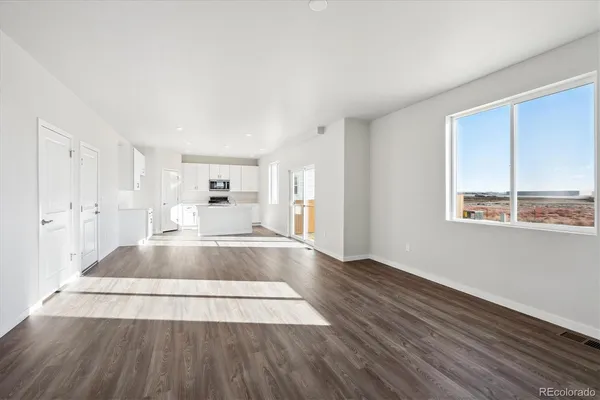 a view of outdoor space with wooden floor and windows