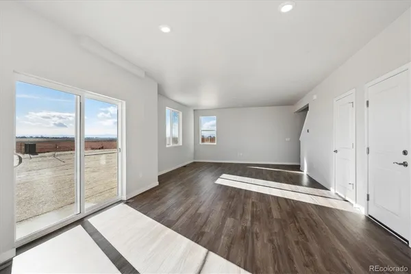 a view of wooden floor and windows in a room