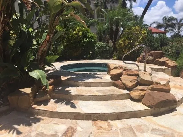 a view of a swimming pool with a yard