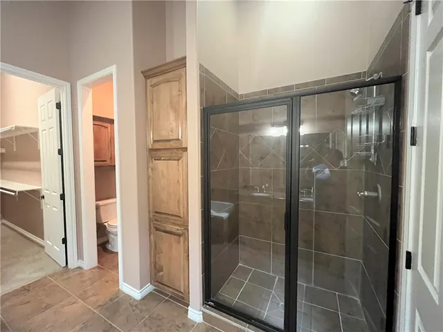 a bathroom with a glass shower door