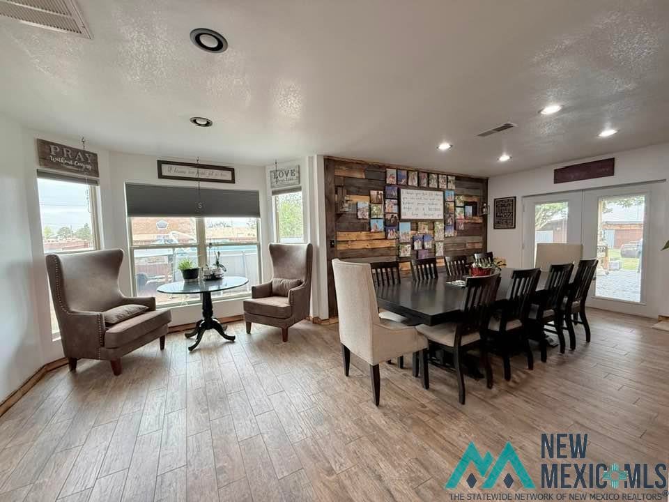 5404 Sioux Road Carlsbad, NM 88220 - Photo 28 of 100 Spacious interior featuring wood-finish tile flooring, recessed lighting, and a wood accent wall