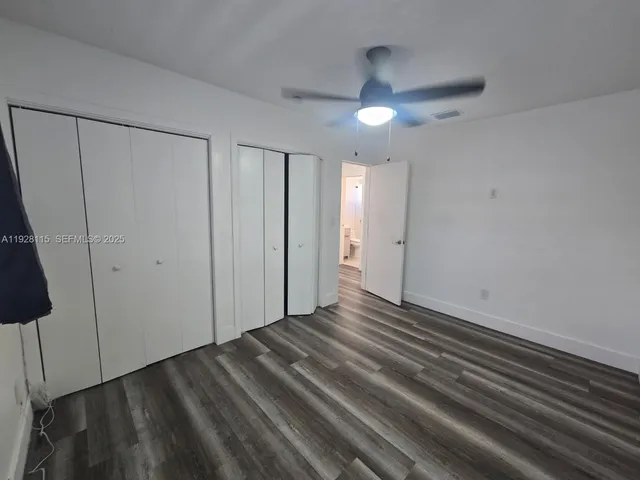 a view of an empty room with a ceiling fan