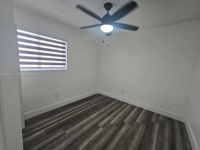 a view of room with window and ceiling fan