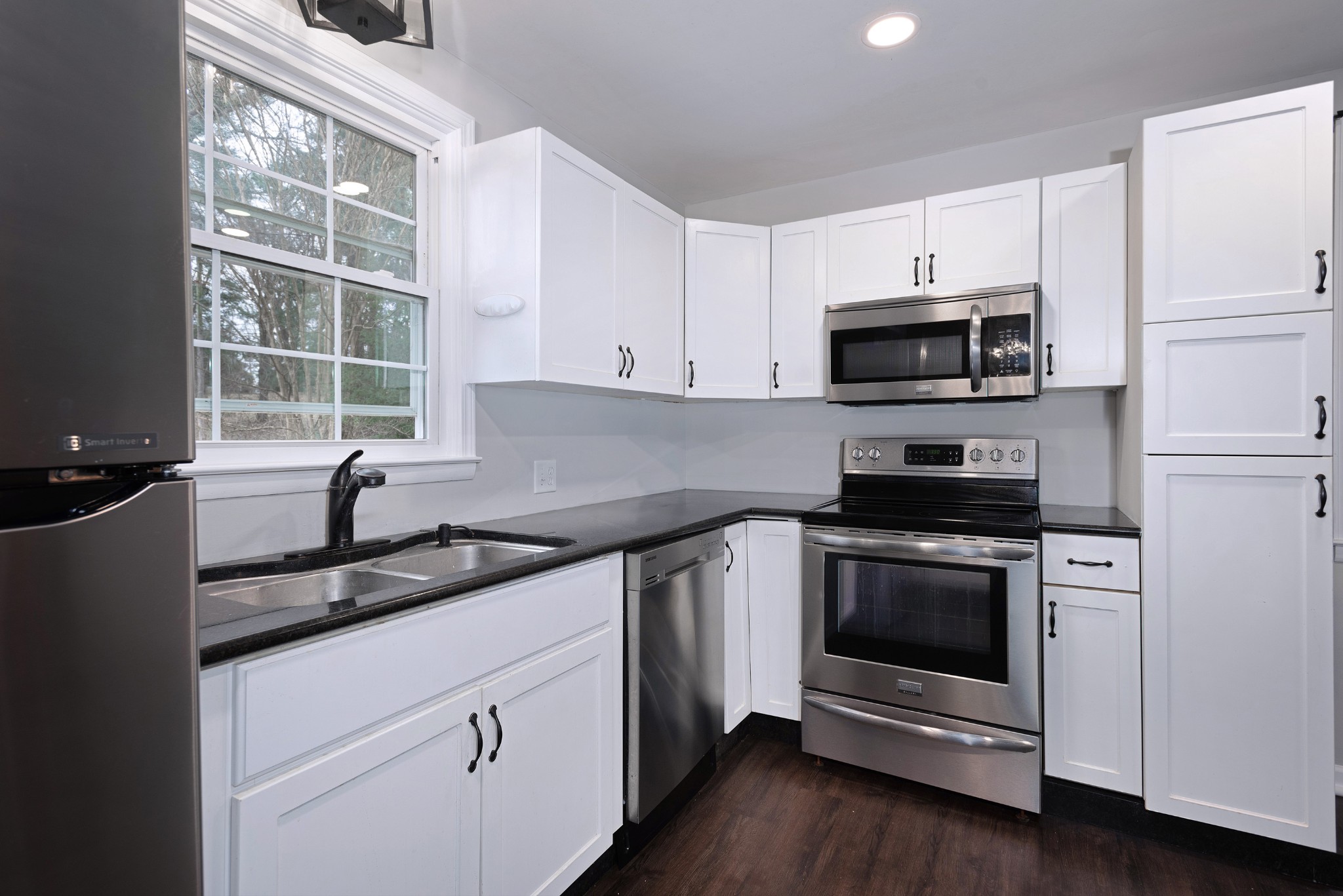 511 North Pawnee Drive Springfield, TN 37172 - Photo 5 of 34 a kitchen with granite countertop white cabinets appliances a window and a sink