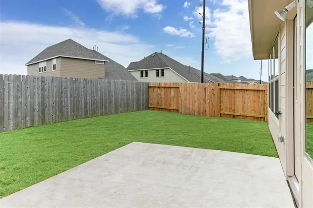 a view of yard with small huts and wooden fence
