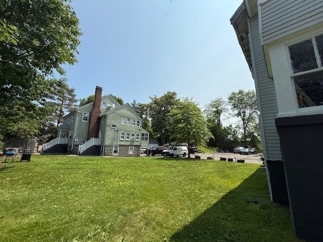 18-38 Beaver Court Framingham, MA 01702 - Photo 5 of 9 a view of a house with a big yard and large trees