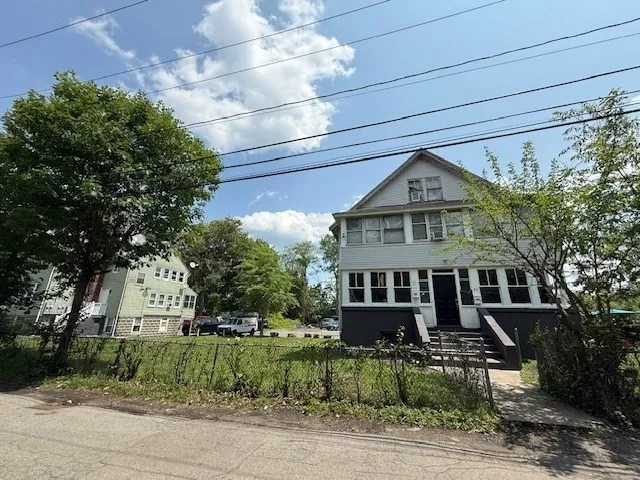 a front view of a house with a yard