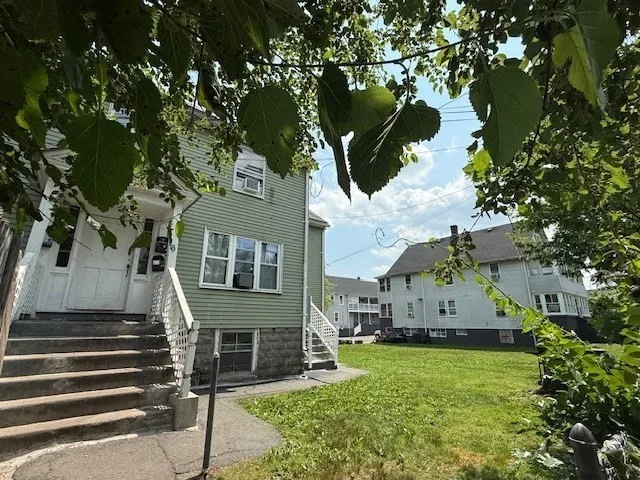 a front view of house with yard and green space