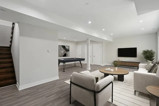 a living room with furniture and a wooden floor