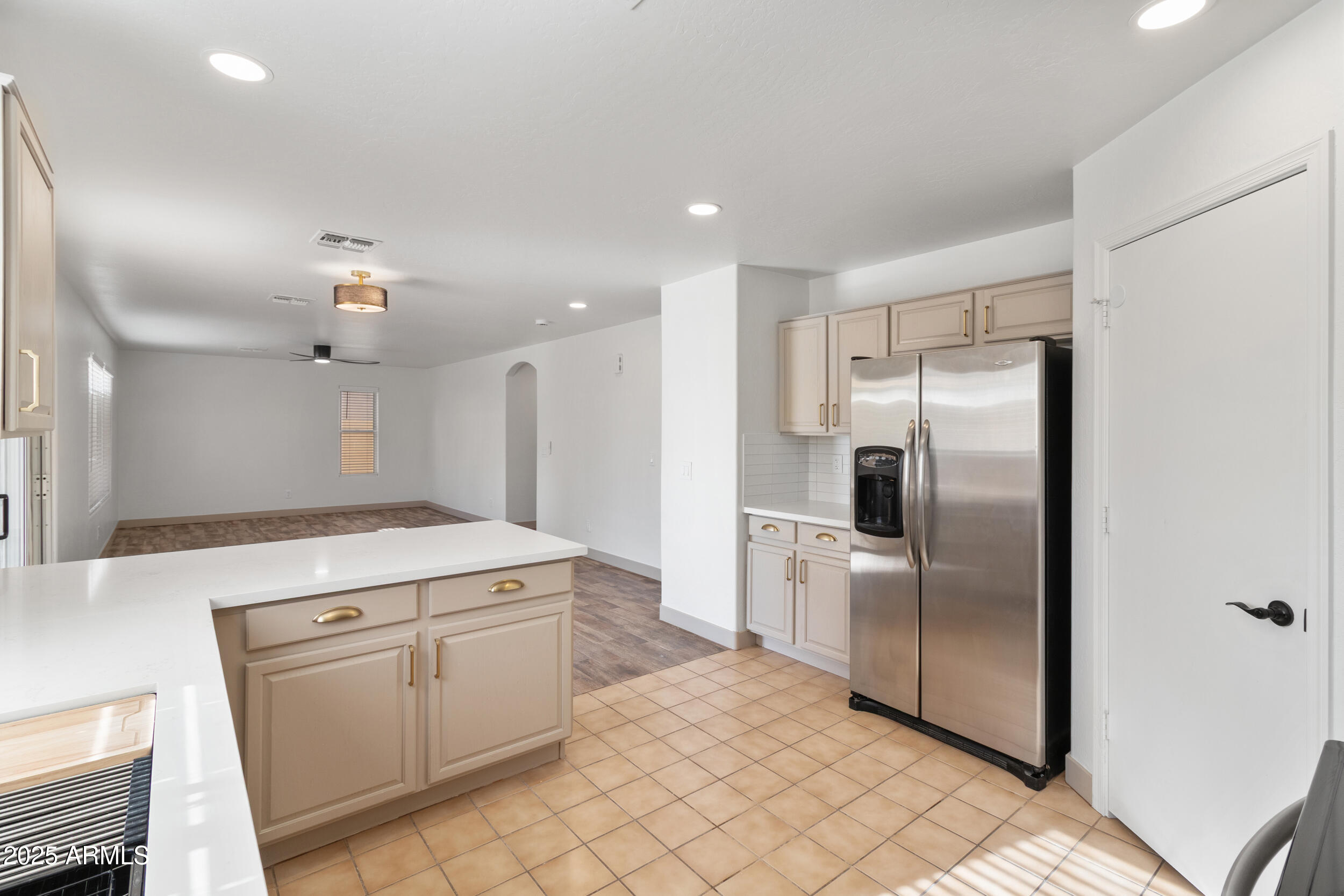 16329 West Rimrock Street Surprise, AZ 85388 - Photo 13 of 31 a kitchen with white cabinets and stainless steel appliances