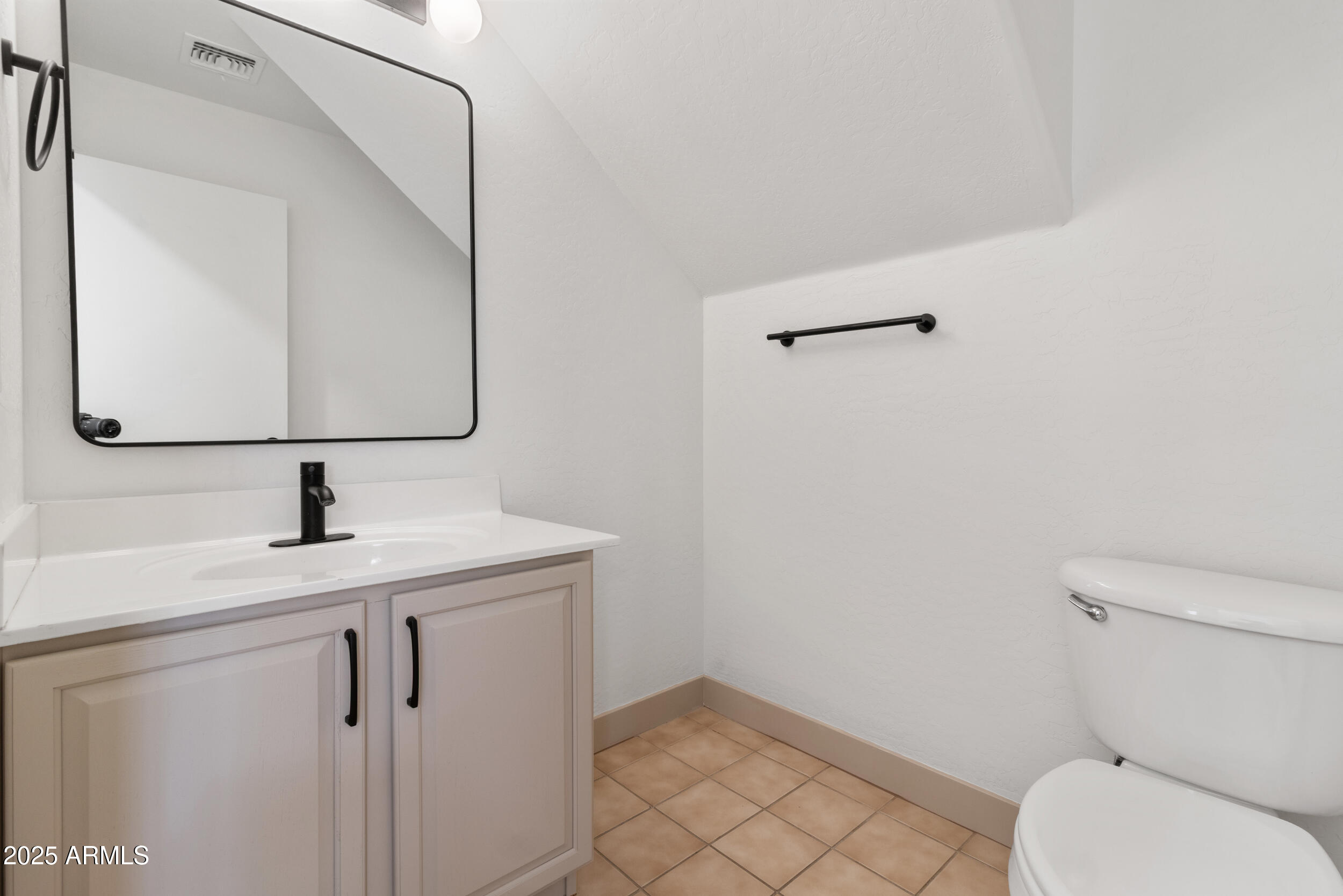 16329 West Rimrock Street Surprise, AZ 85388 - Photo 14 of 31 a bathroom with a granite countertop toilet sink and mirror