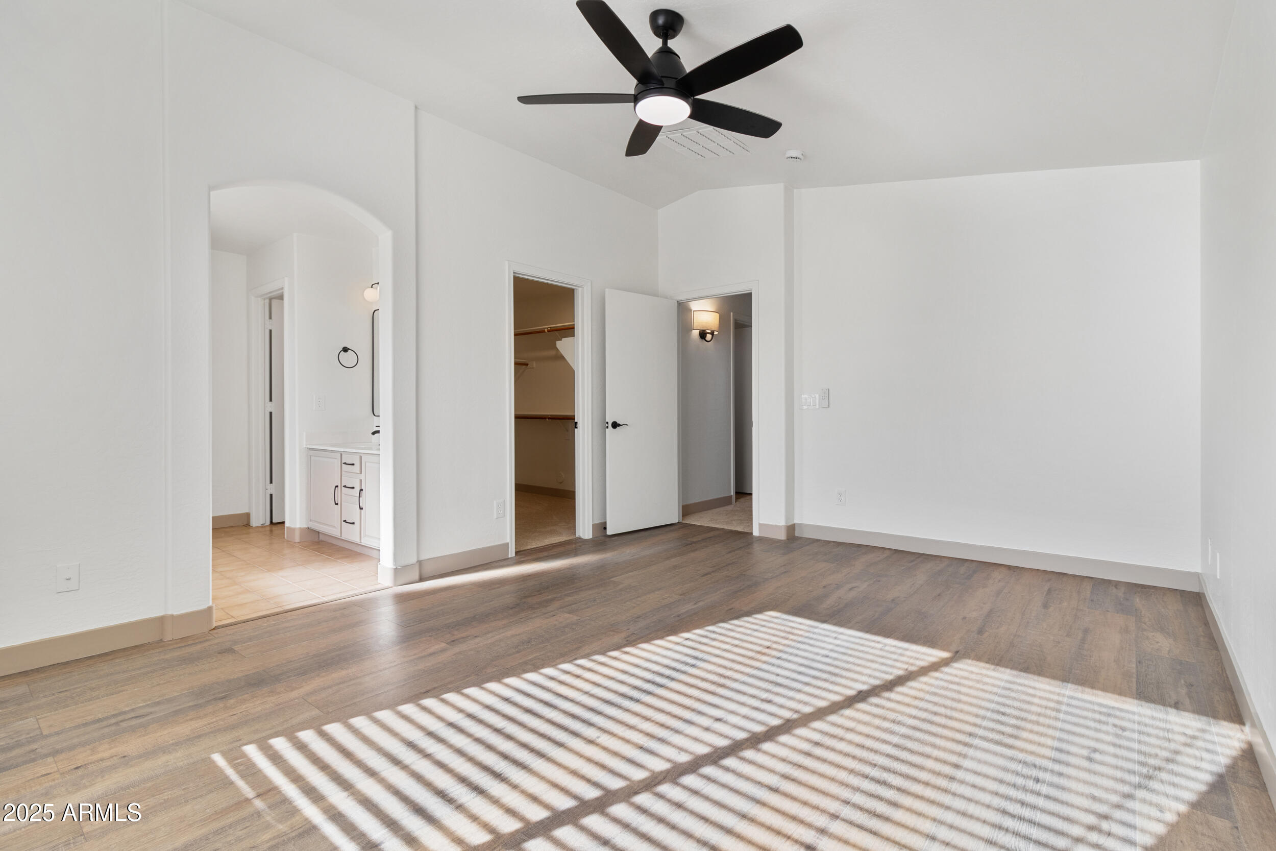 16329 West Rimrock Street Surprise, AZ 85388 - Photo 18 of 31 an empty room with wooden floor and ceiling fan