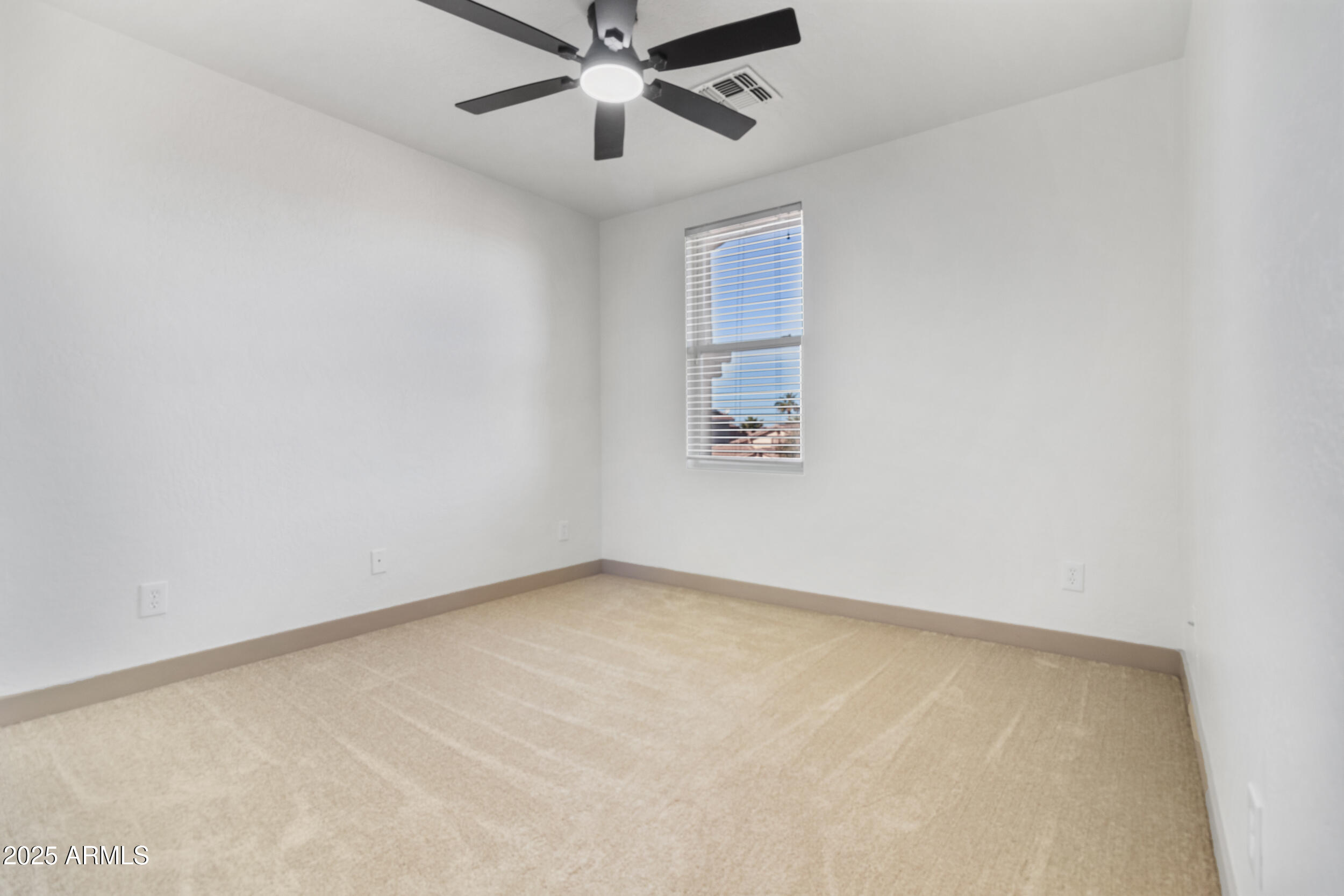16329 West Rimrock Street Surprise, AZ 85388 - Photo 22 of 31 an empty room with a window and a fan