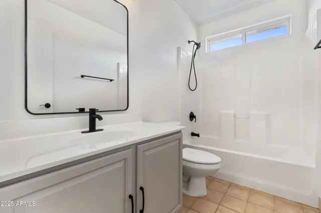 a bathroom with a sink toilet vanity and shower