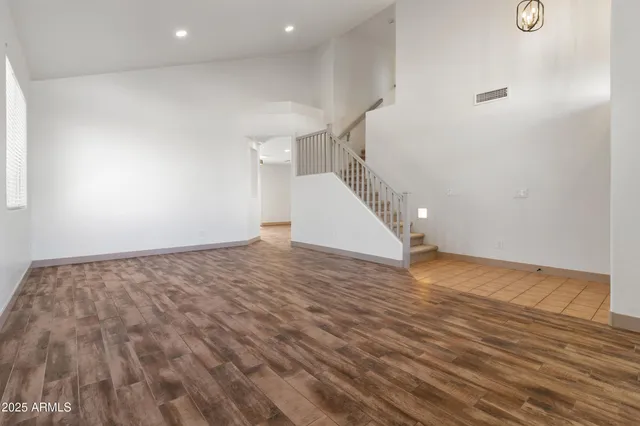 a view of a room with wooden floor