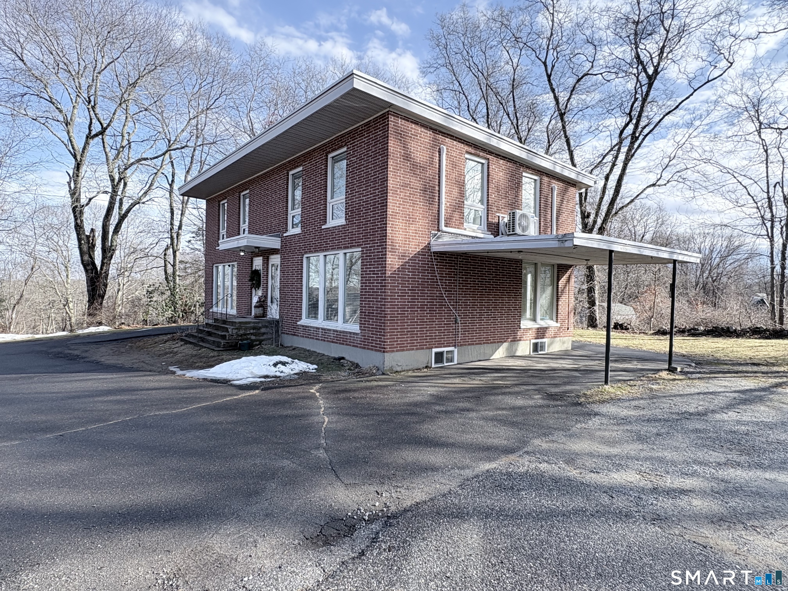 a front view of a house with a road