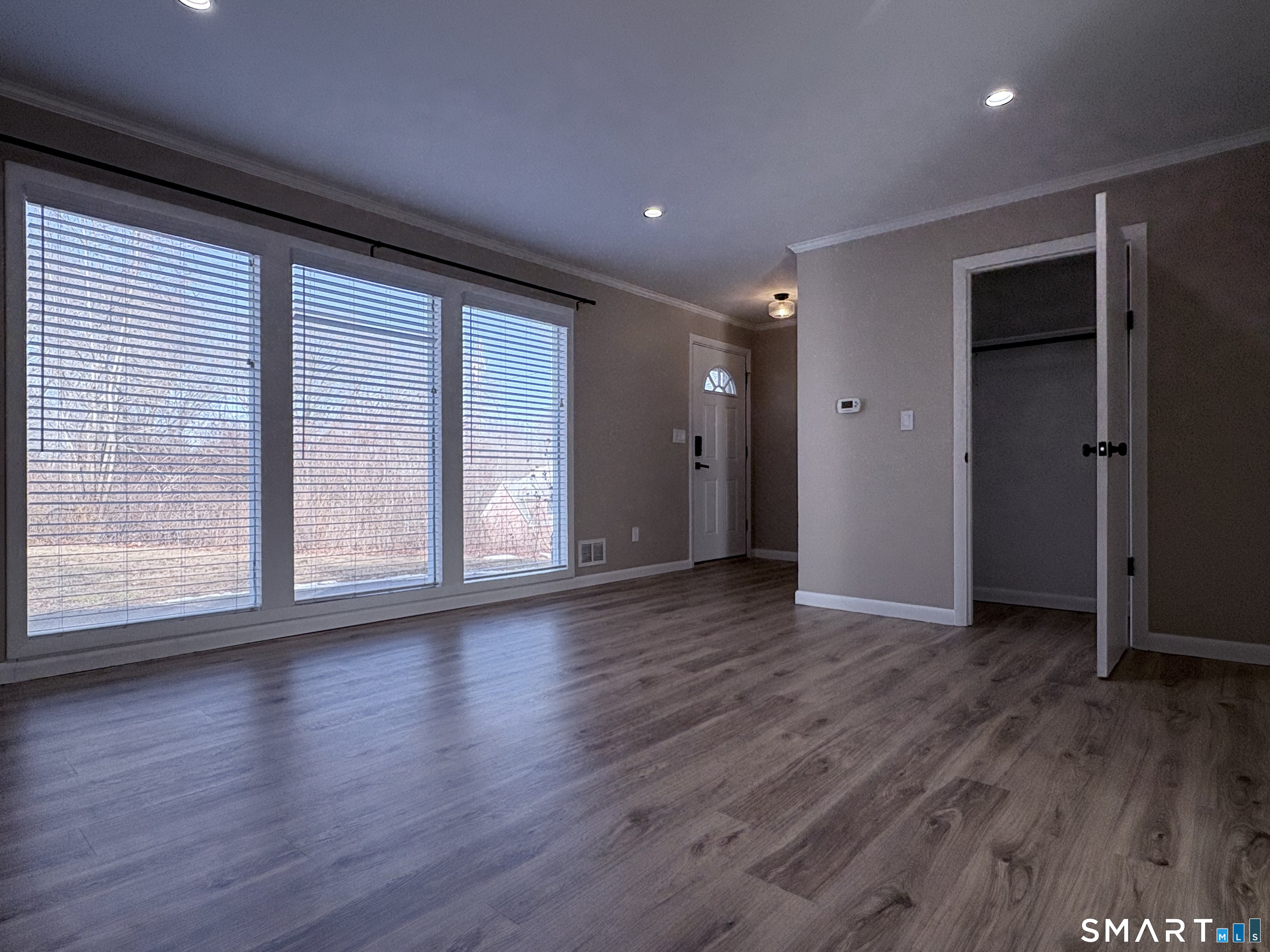 80 A Balaban Road, Unit A/ON Colchester, CT 06415 - Photo 12 of 24 a view of an empty room with wooden floor and a window