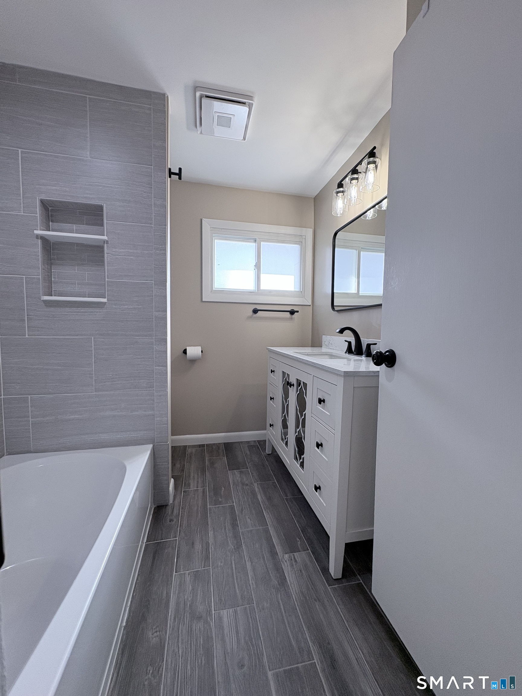 80 A Balaban Road, Unit A/ON Colchester, CT 06415 - Photo 16 of 24 a bathroom with a sink a mirror and a bathtub