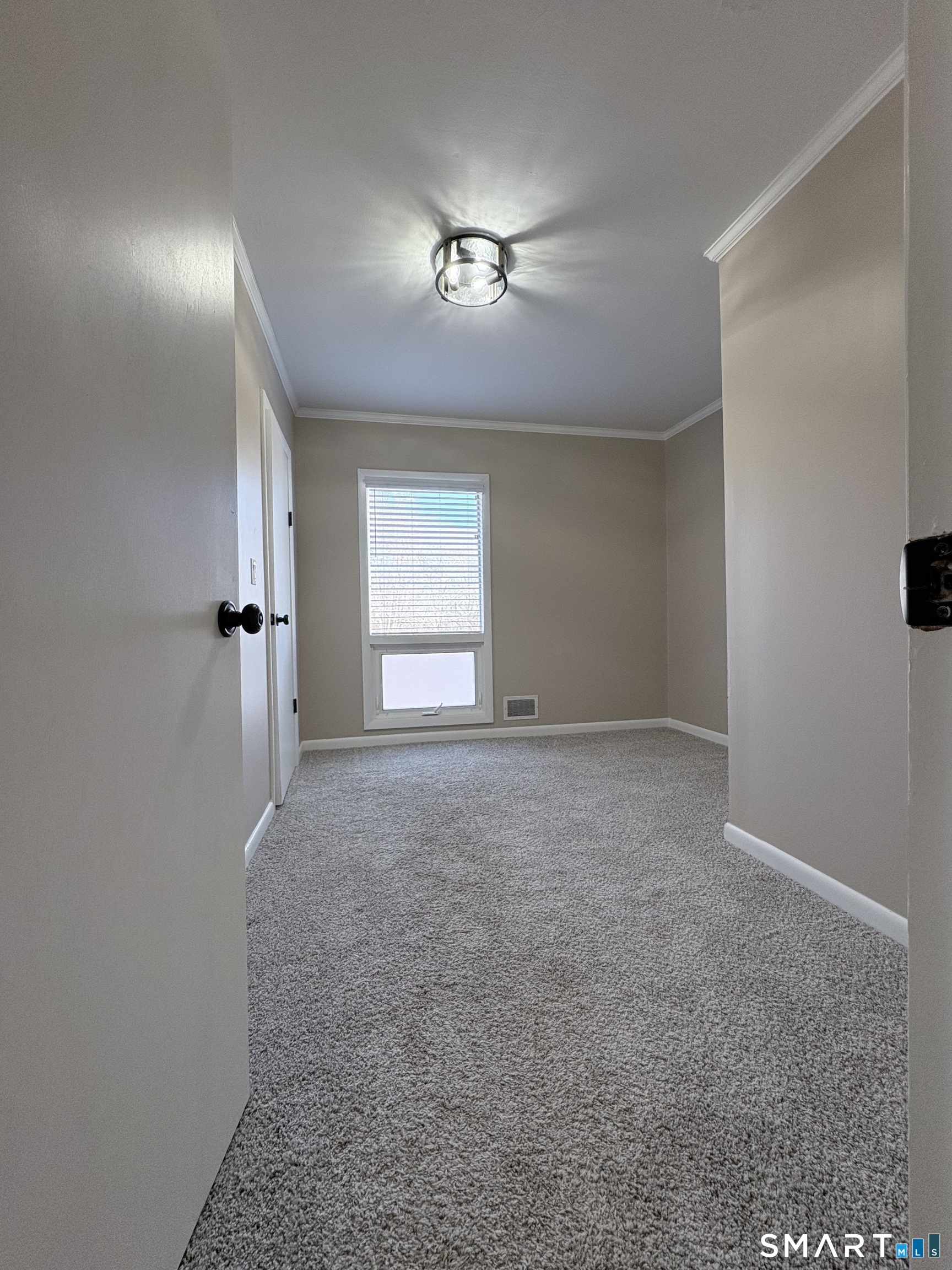 80 A Balaban Road, Unit A/ON Colchester, CT 06415 - Photo 19 of 24 an empty room with chandelier fan and windows
