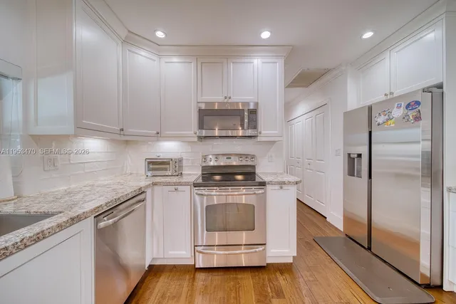 a kitchen with a stove top oven and refrigerator