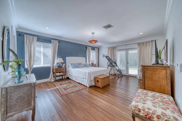 a bedroom with furniture and a wooden floor