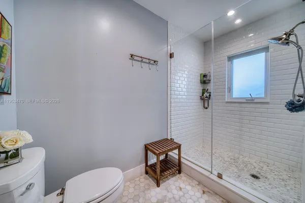 a bathroom with a toilet a sink and shower